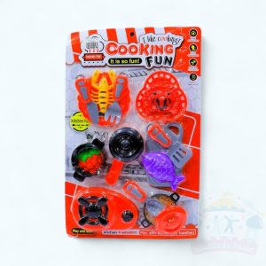 عروسة مع ادوات مطبخ سمك